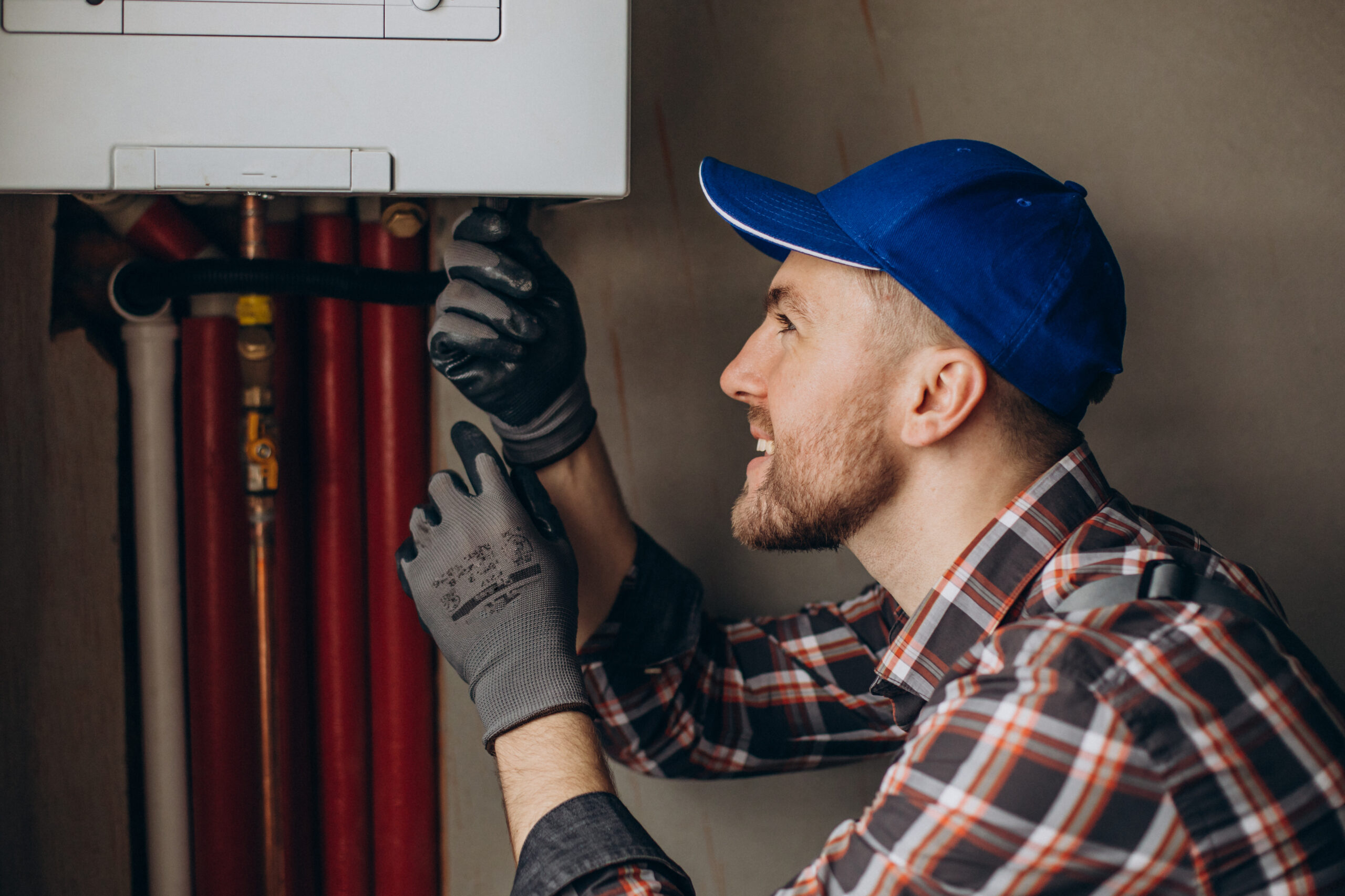 Service man installing gas furnace.