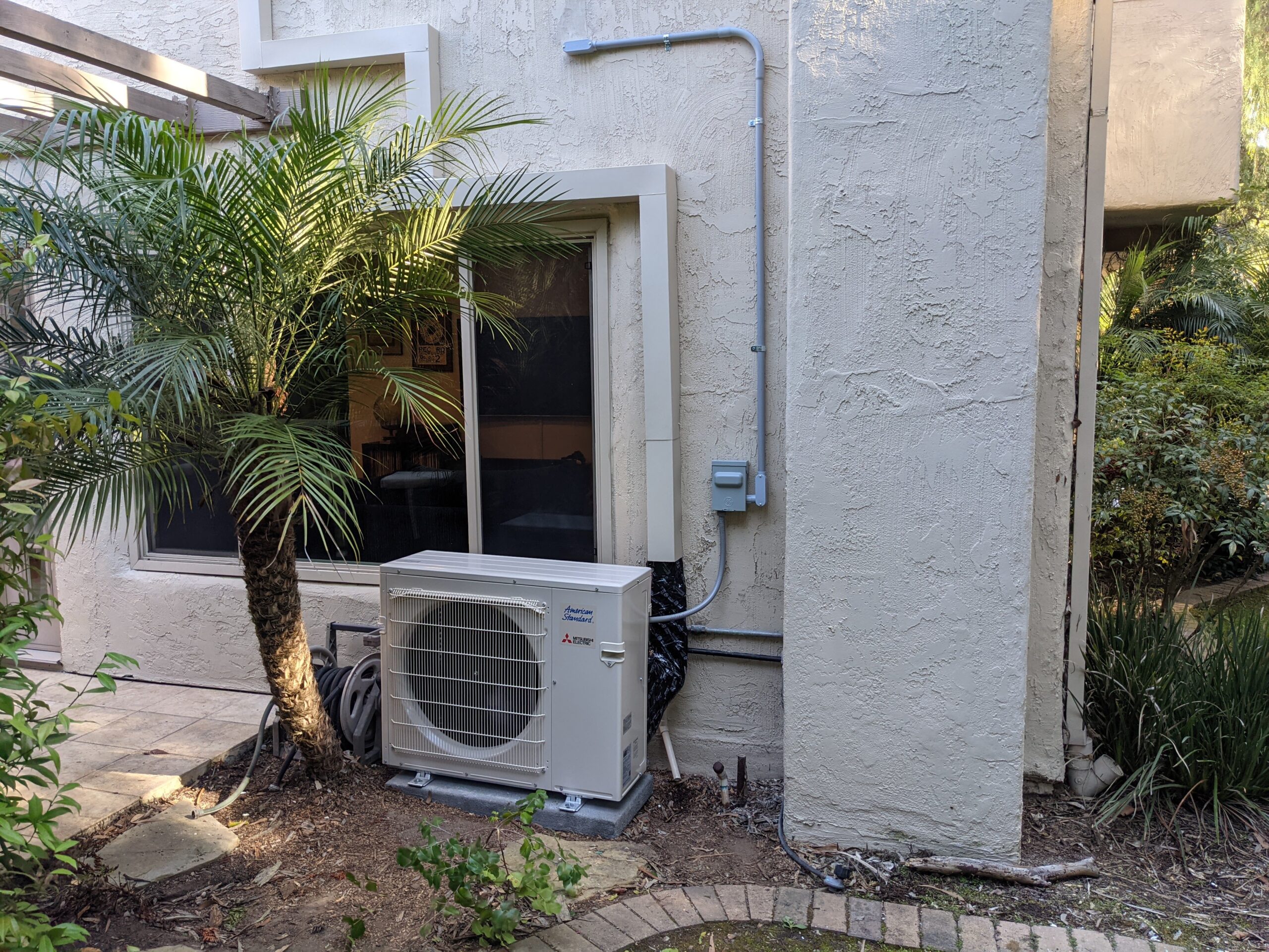 Mitsubishi Mini Split AC near palm in San Diego. Installed by Accord Air.