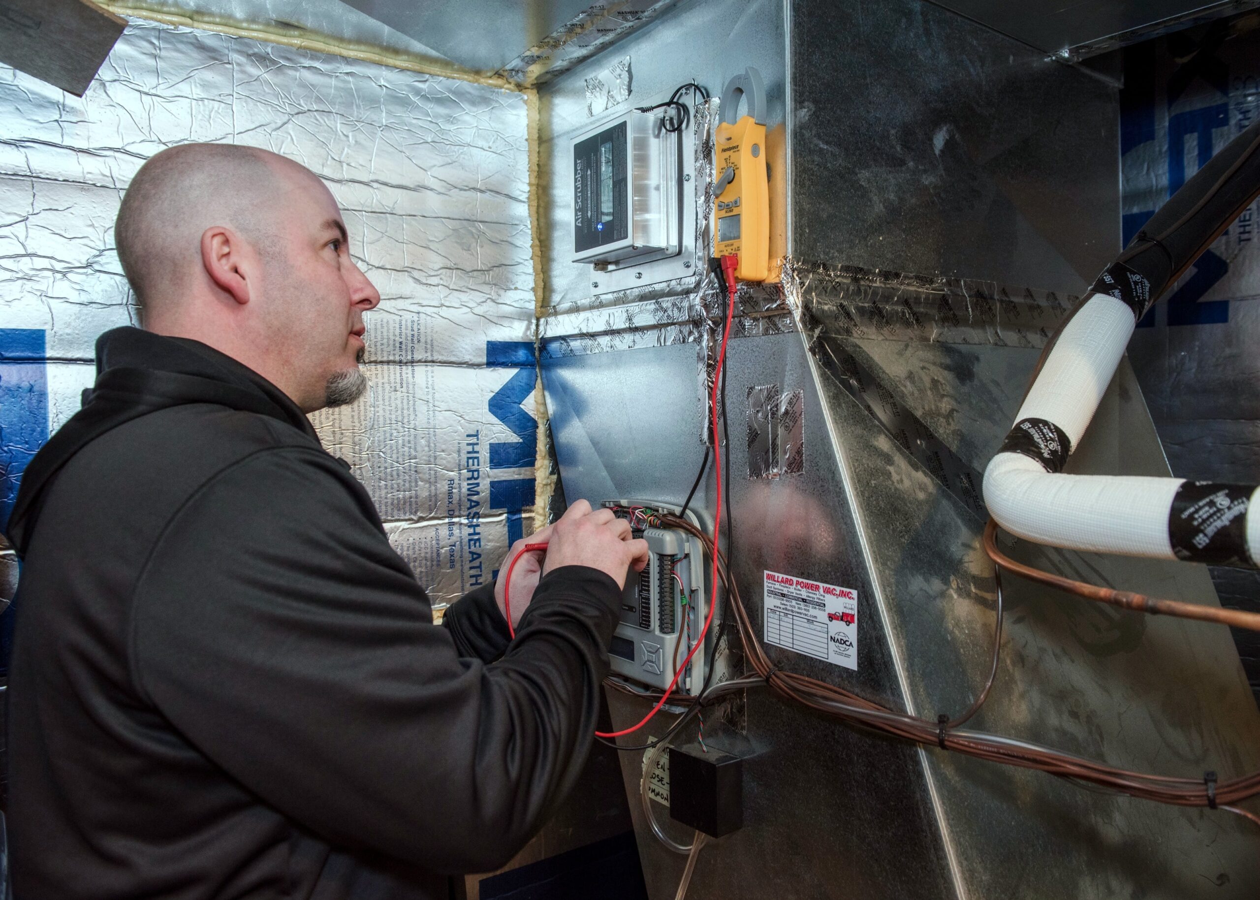 The technician installs the gas furnace.